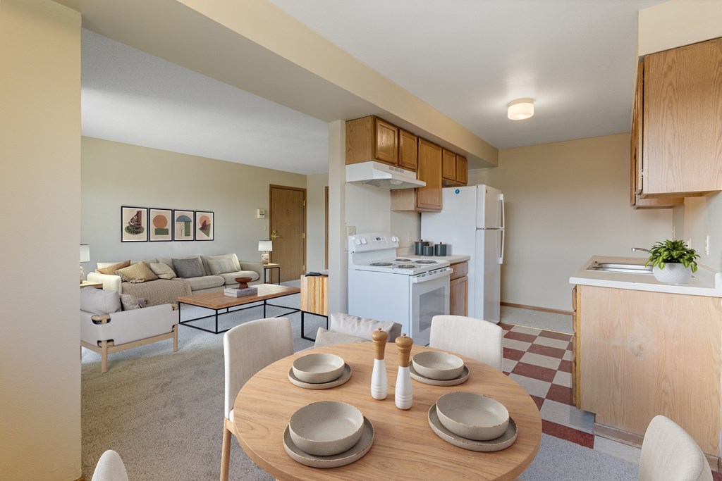 A modern kitchen with a dining table set for two.