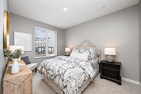 Bedroom with upholstered headboard and dual nightstands at Reserve At Settlers Ridge Apartments, Woodbury, MN 55129