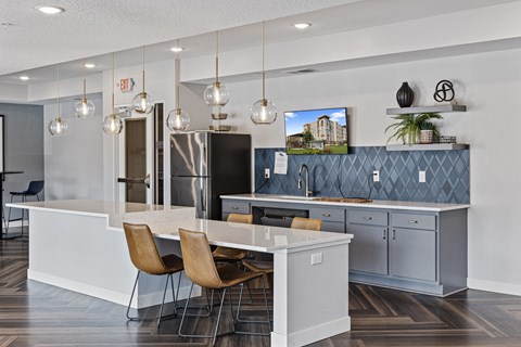a kitchen with a white counter top and blue cabinets