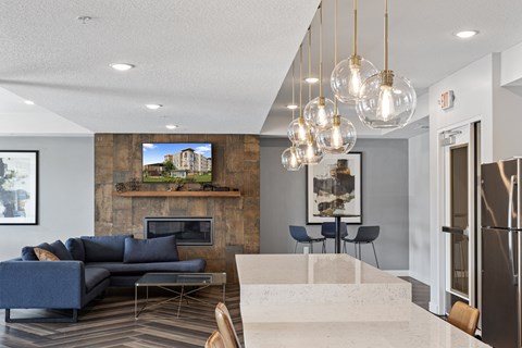 a living room with couches and a table and a kitchen