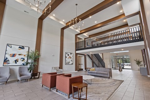 a lobby with couches and chairs and a staircase