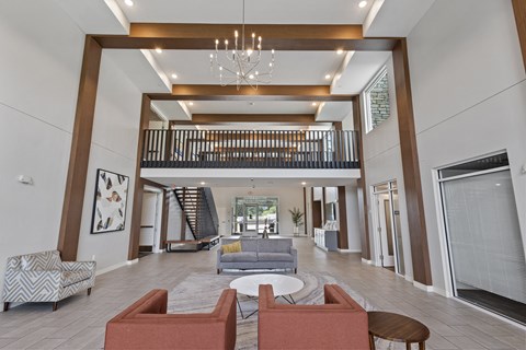 a lobby with couches and chairs and a chandelier