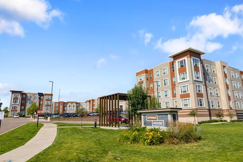 a city street with an apartment building and a sidewalk