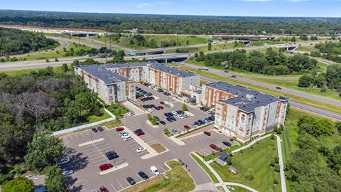 an aerial view of an apartment complex and parking lot