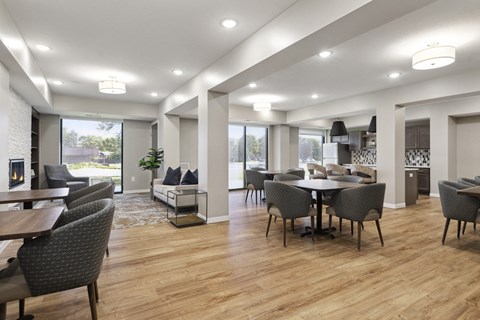 A modern living room with a dining table and chairs at Sonder Point 50+ Apartments, Brooklyn Center, MN