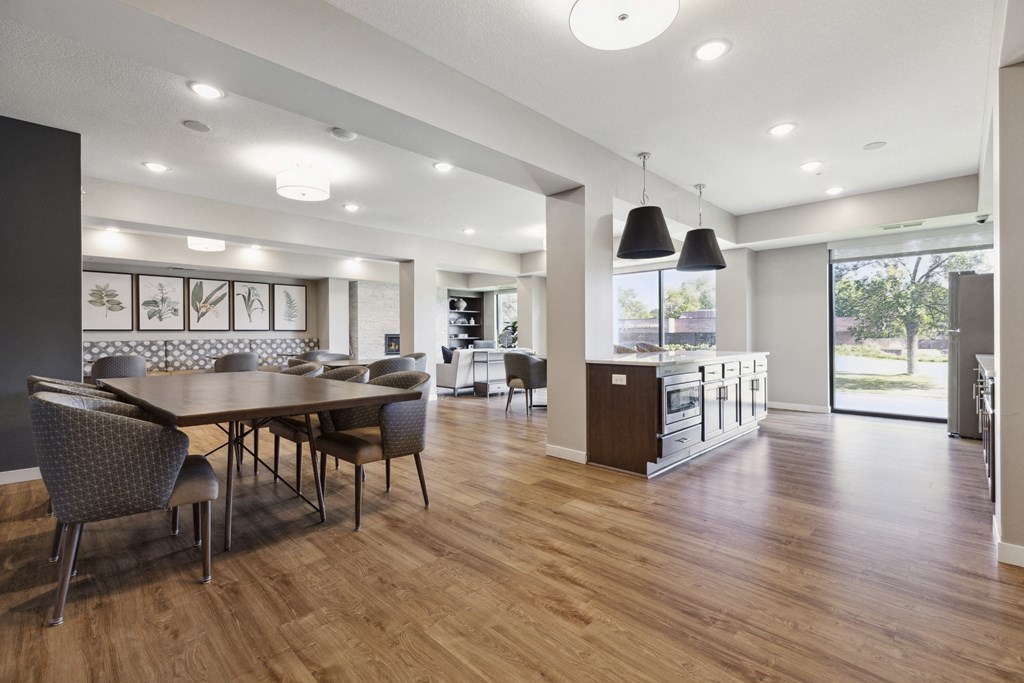 A modern dining room with a wooden table and chairs at Sonder Point 50+ Apartments, Brooklyn Center, MN, 55430