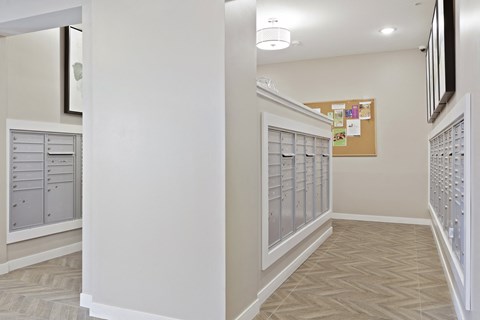 A hallway with a bulletin board on the wall at Sonder Point 50+ Apartments, Brooklyn Center, Minnesota