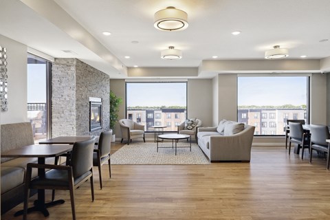 A spacious living room with a dining table and chairs at Sonder Point 50+ Apartments, Brooklyn Center, 55430