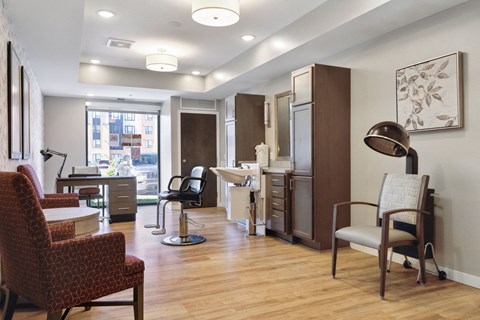 A room with a desk, chairs and a lamp at Sonder Point 50+ Apartments, Minnesota