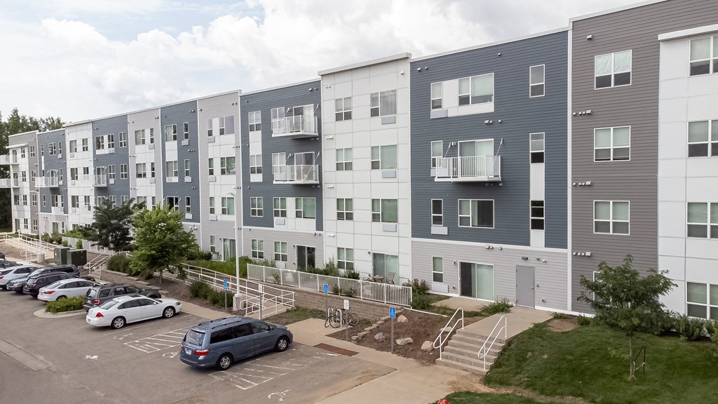 an image of an apartment building with cars parked in a parking lot at Technology Park Apartments, Rochester, 55901