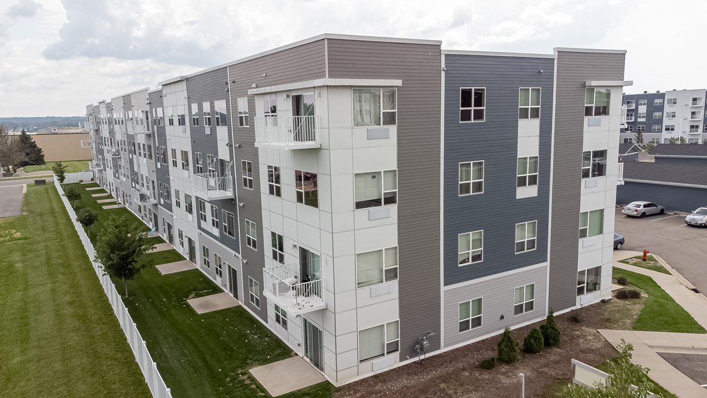 an aerial view of an apartment building with green grass and a parking lot at Technology Park Apartments, Rochester, MN, 55901