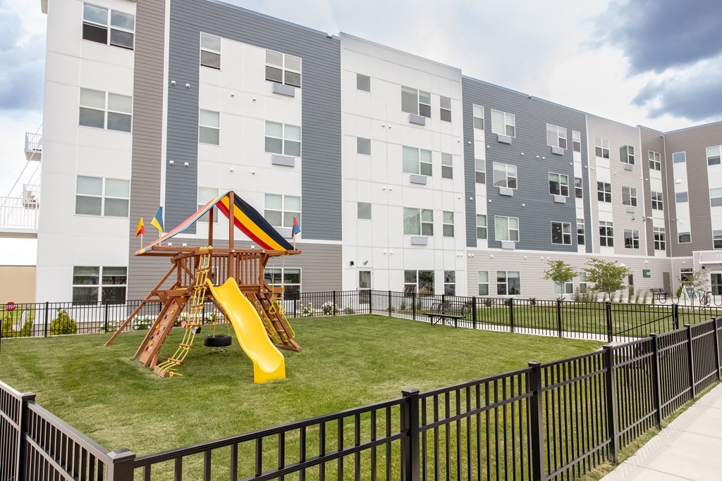 a playground in the middle of an apartment building with a slide at Technology Park Apartments, Minnesota