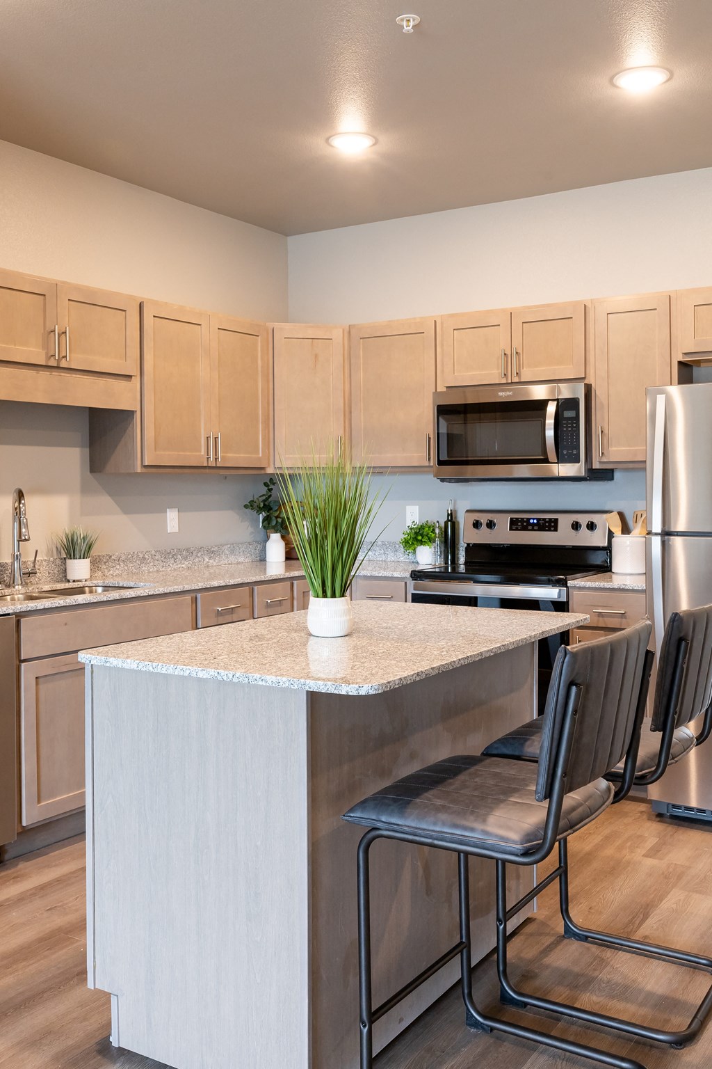a kitchen with a large island and stainless steel appliances at Technology Park Apartments, Minnesota