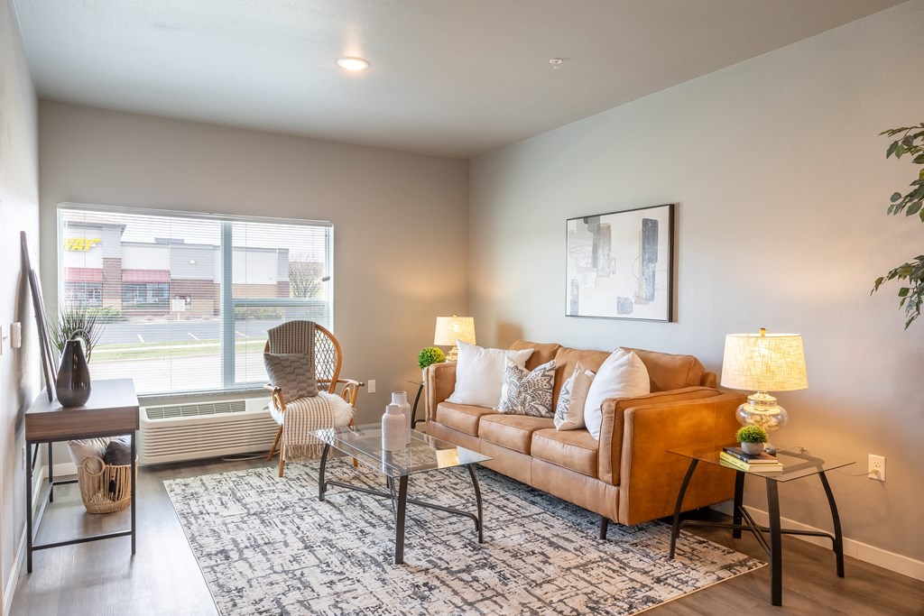 an open living room with a couch and a window at Technology Park Apartments, Minnesota, 55901