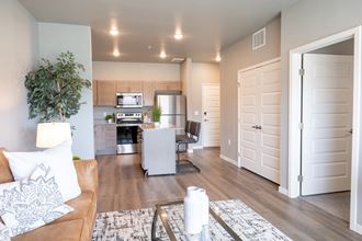 a living room and kitchen with a couch and a table