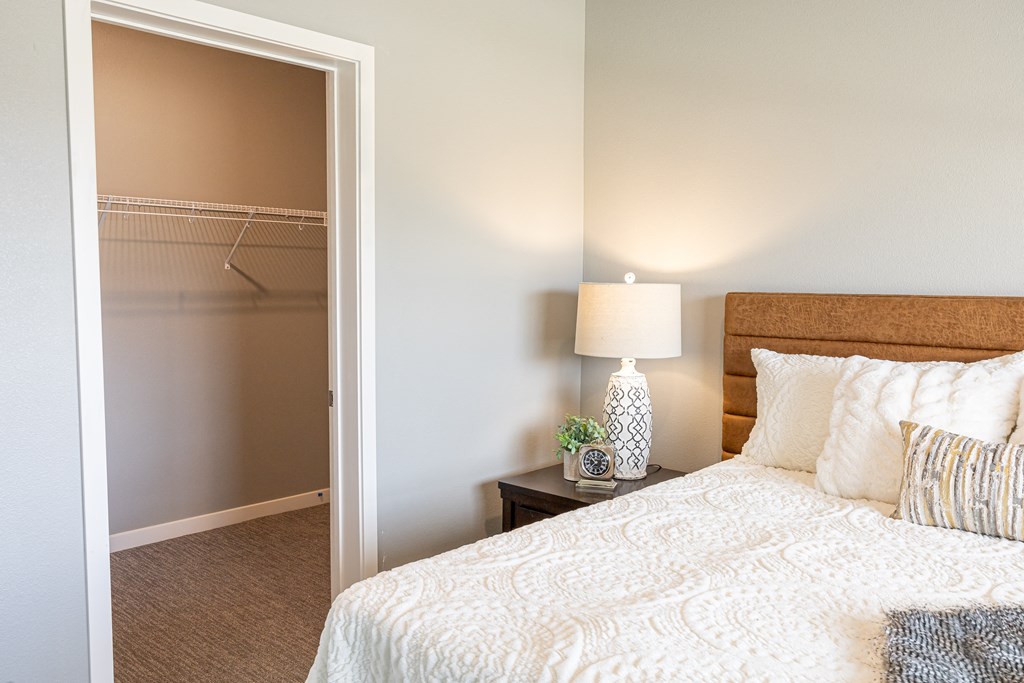 a bedroom with a bed and a closet at Technology Park Apartments, Rochester, MN