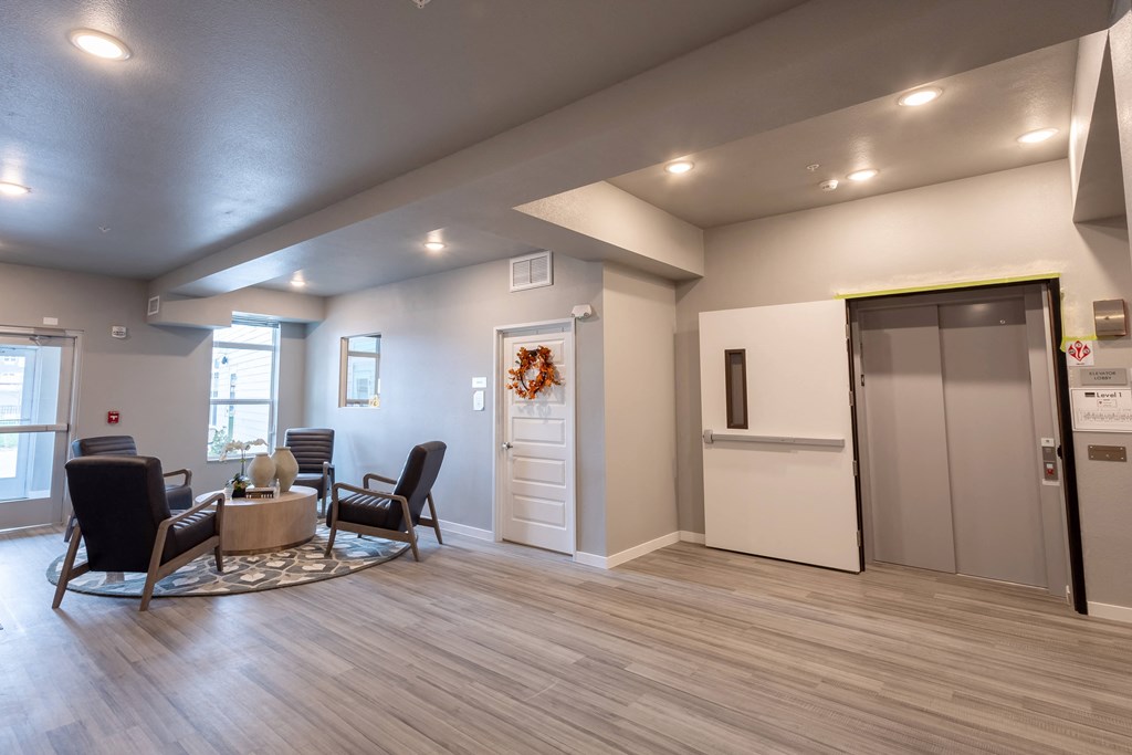 the clubhouse at the champion apartments has a living room and kitchen at Technology Park Apartments, Rochester, MN