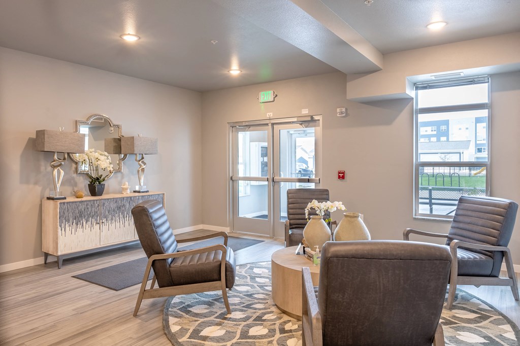 a living room with chairs and a table and a fireplace at Technology Park Apartments, Rochester, MN, 55901