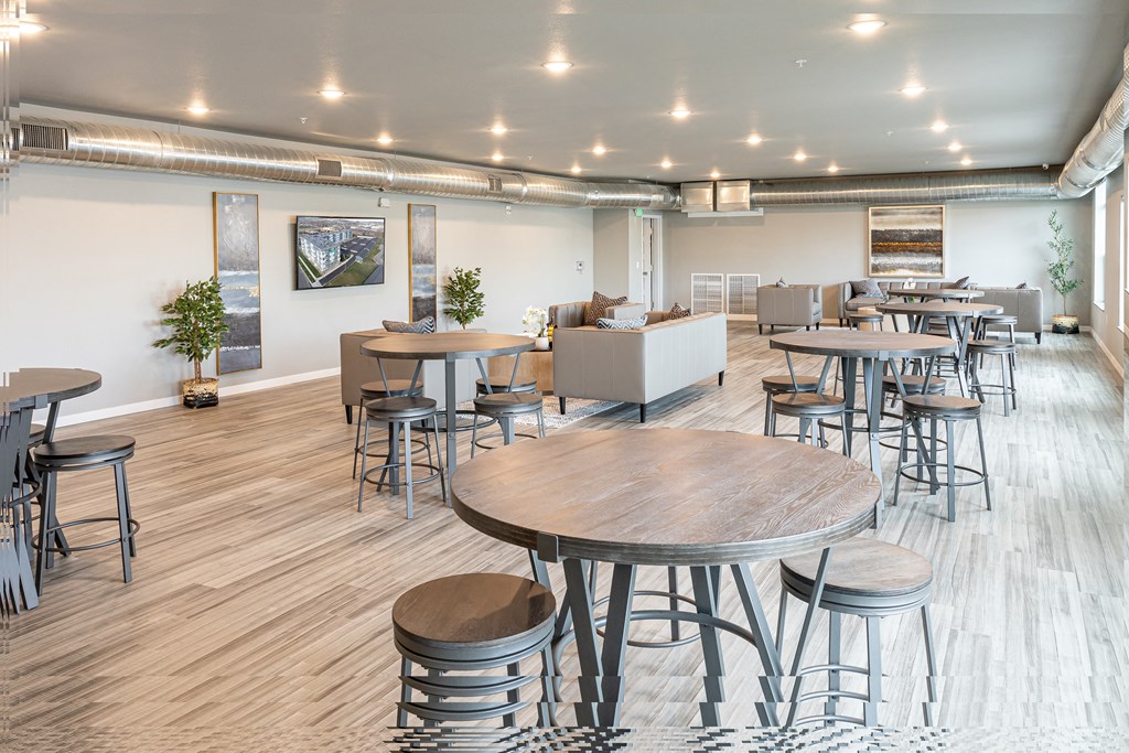 a communal area with tables and chairs in a large room at Technology Park Apartments, Rochester