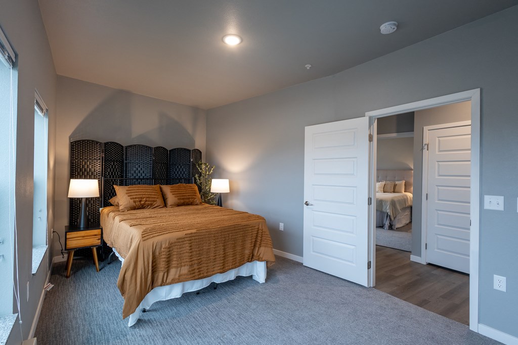 a bedroom with a bed and a door to a bathroom at Technology Park Apartments, Minnesota