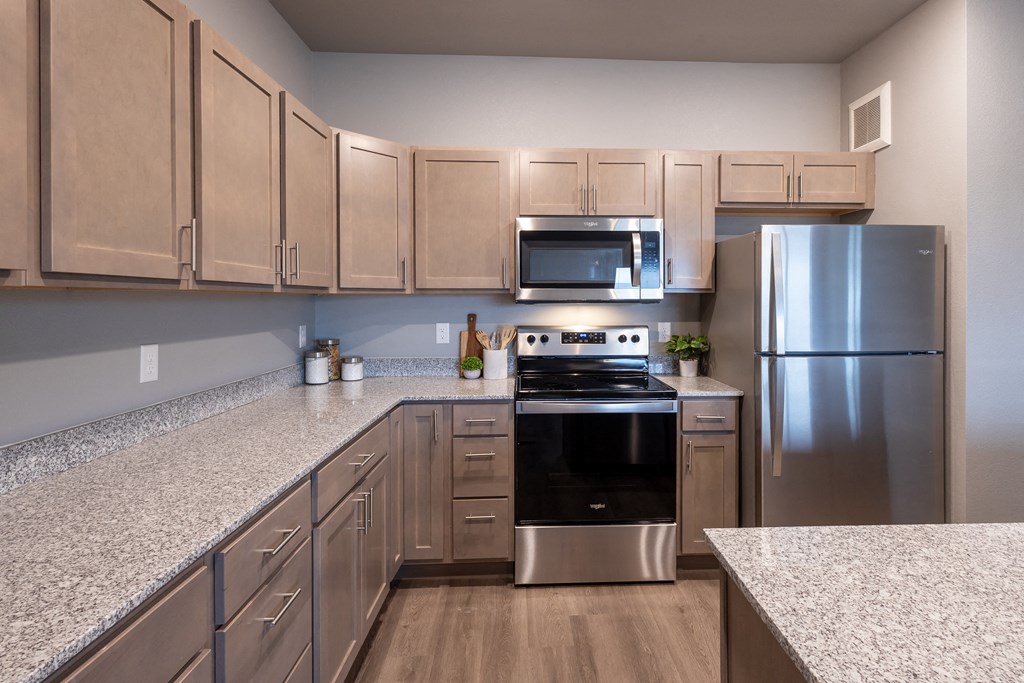 a kitchen with granite counter tops and stainless steel appliances at Technology Park Apartments, Rochester, 55901