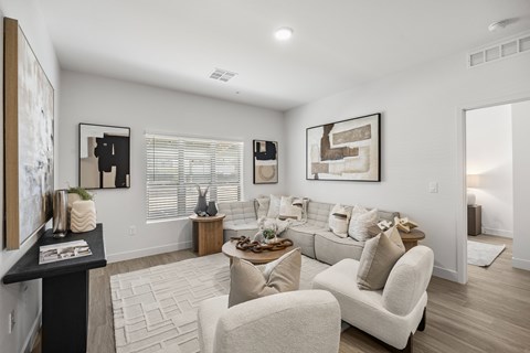 A living room with a white couch and a coffee table.