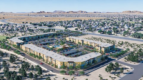 A large, modern building complex is surrounded by a parking lot and a residential neighborhood.