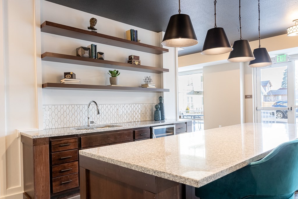 a kitchen with a marble counter top and a sink