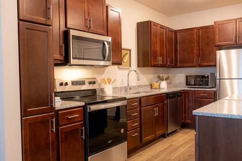 a kitchen with wood cabinets and stainless steel appliances and a counter top