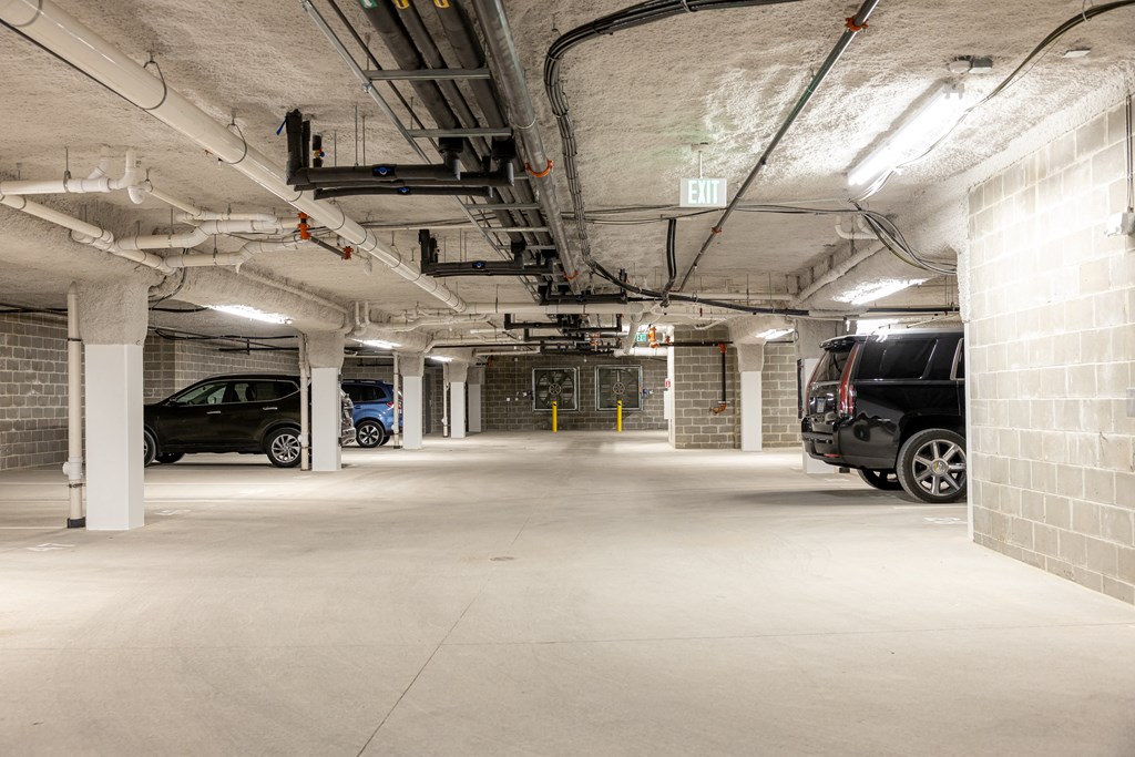 the underground parking garage of a building with parked cars