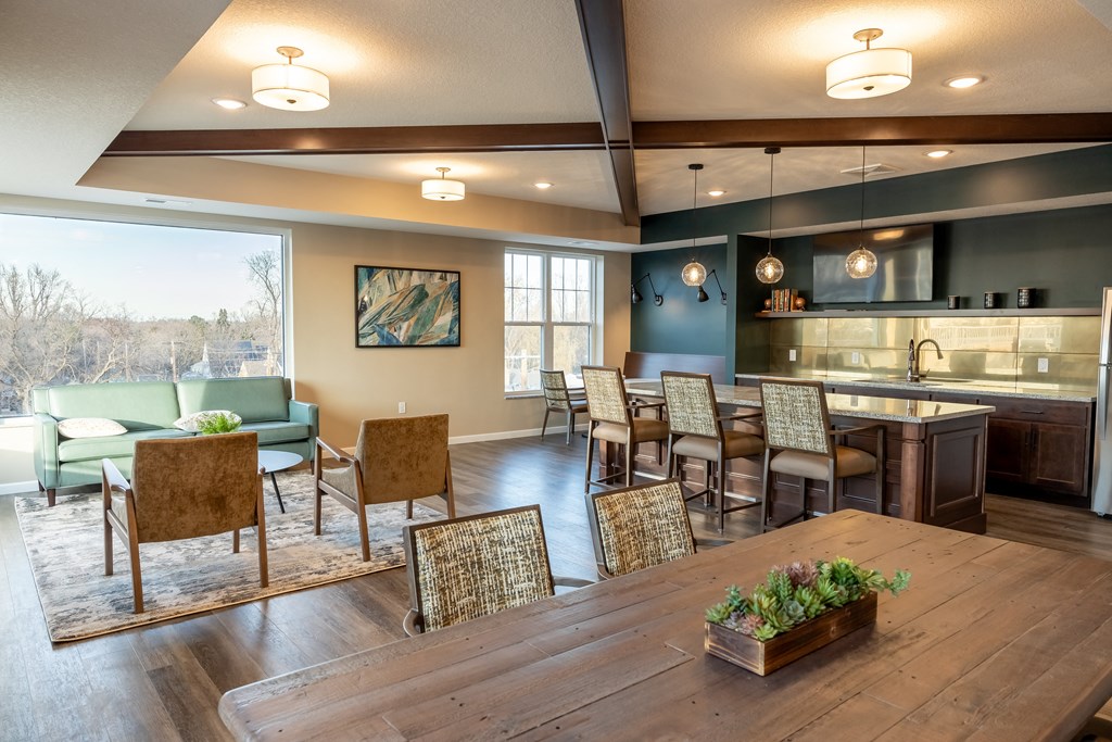 a dining room with a table and chairs and a kitchen with a large window