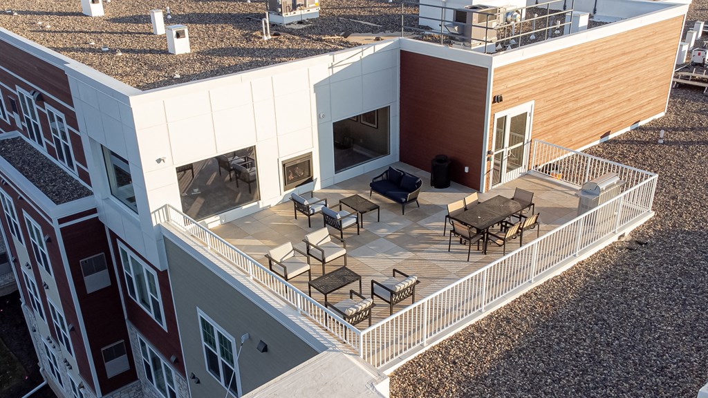 arial view of a building with a balcony and tables and chairs