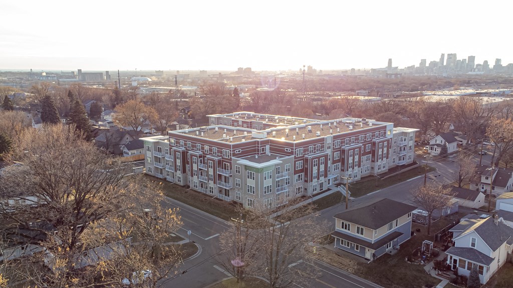 an aerial view of a large building with a city in the background