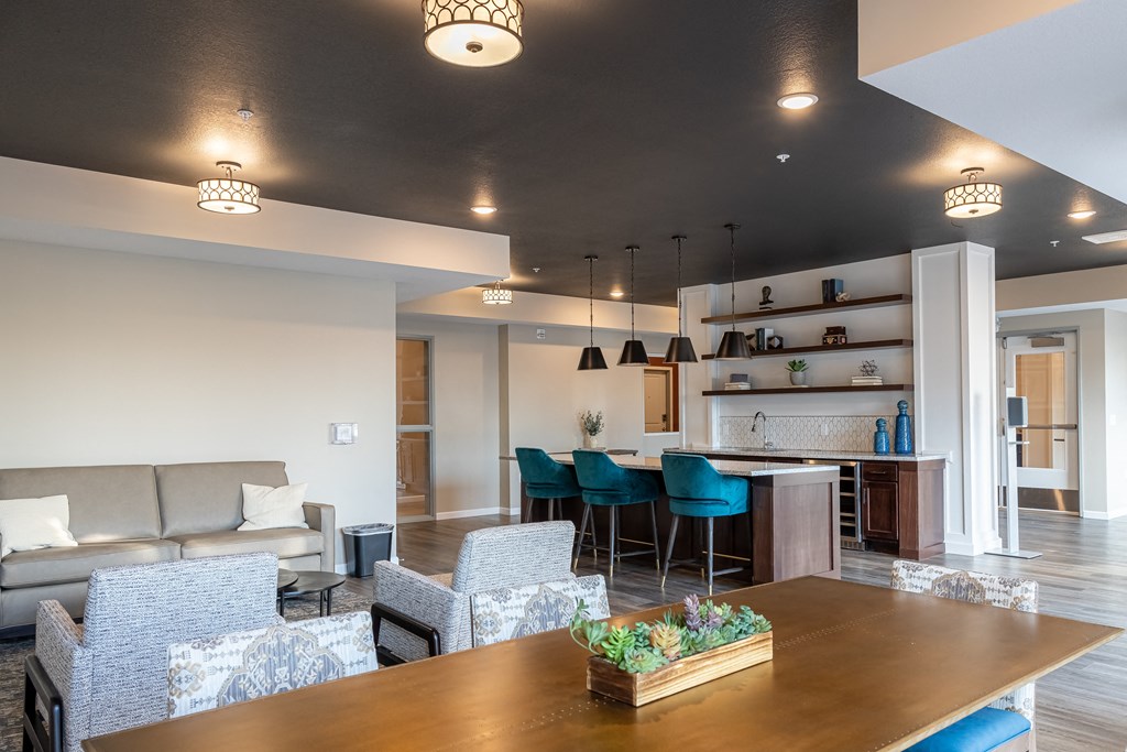 a living room and kitchen with a table and chairs