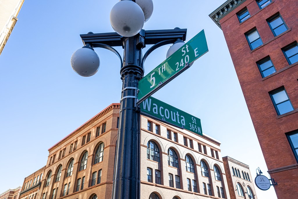 a street light with street signs on it in front of a building