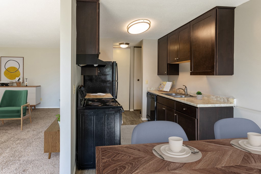 the view of a kitchen and dining room with a table and chairs at Villa Del Coronado Apartments, Minnesota, 55443