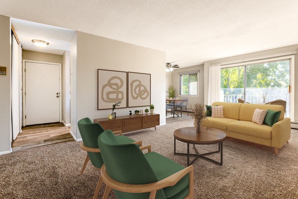 a living room with a yellow couch and green chairs at Villa Del Coronado Apartments, Brooklyn Park
