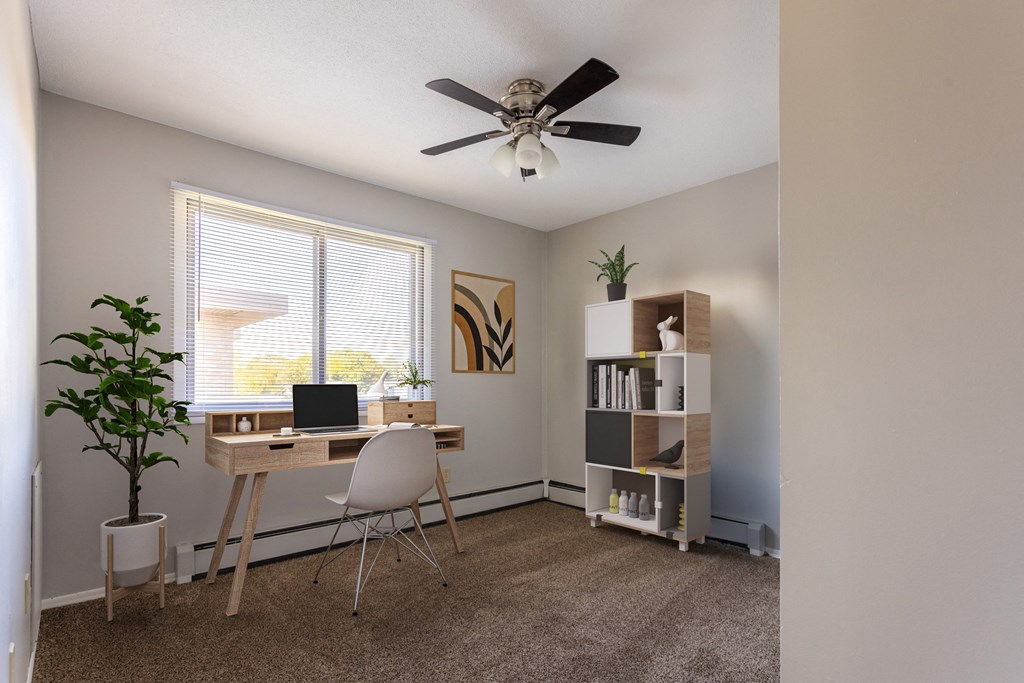an office with a ceiling fan and a desk with a laptop at Villa Del Coronado Apartments, Brooklyn Park, 55443