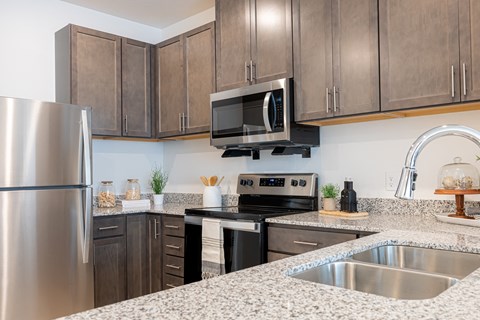 a kitchen with granite counter tops and stainless steel appliances