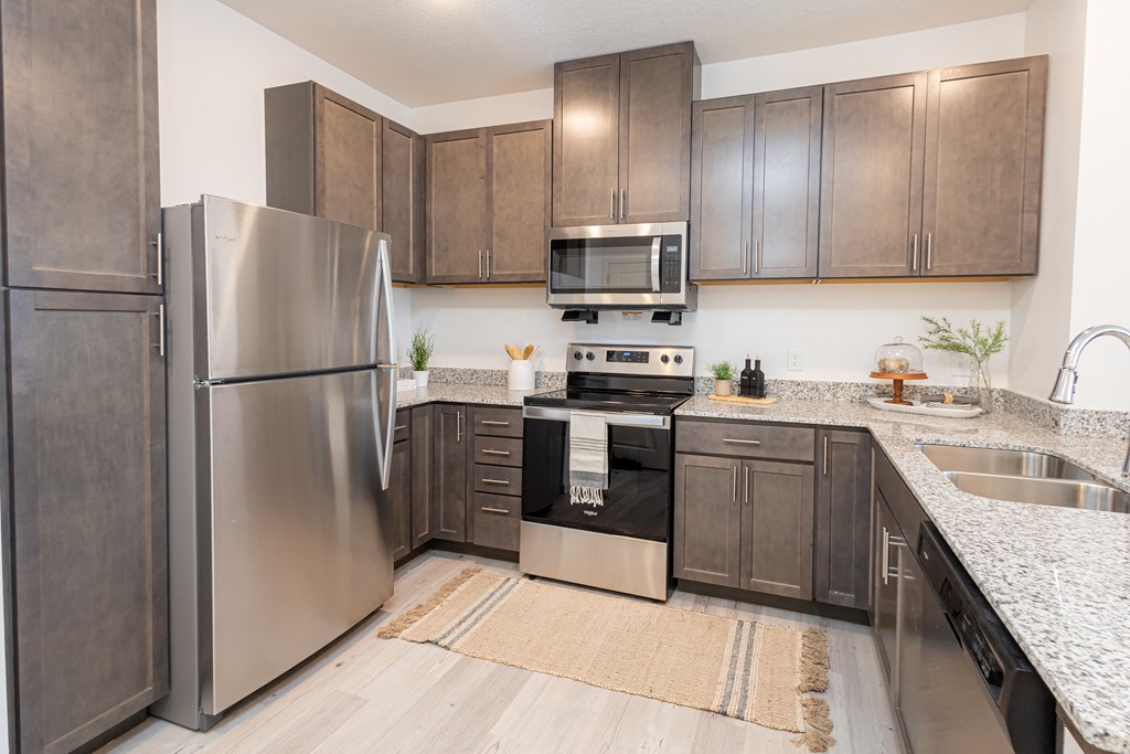 a kitchen with stainless steel appliances and wooden cabinets