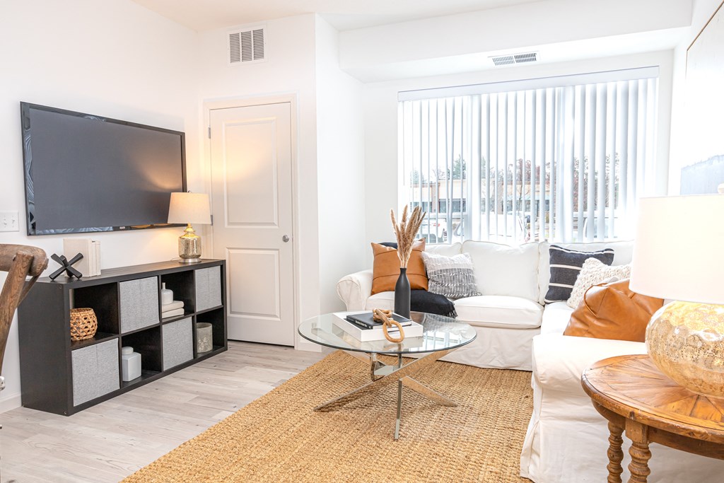 a living room with a couch and a table and a television
