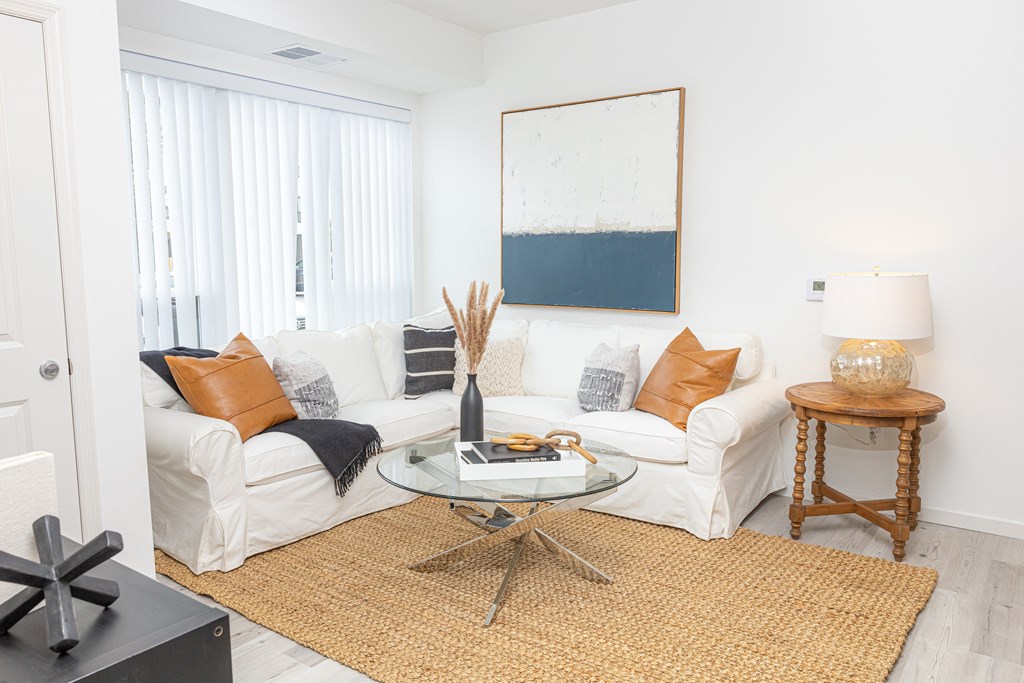 a living room with a white couch and a table
