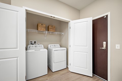 A laundry room with a washer and dryer in it at The Winslow 62+ Apartments, West St Paul, MN