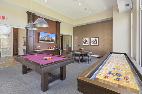 a game room with two pool tables and a billiard table at The Winslow 62+ Apartments, West St Paul