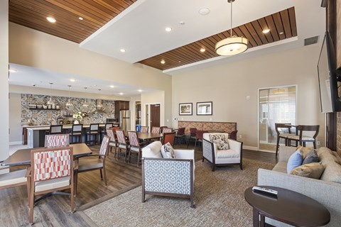 a living room with couches and chairs and a dining room with tables and chairs at The Winslow 62+ Apartments, Minnesota, 55118