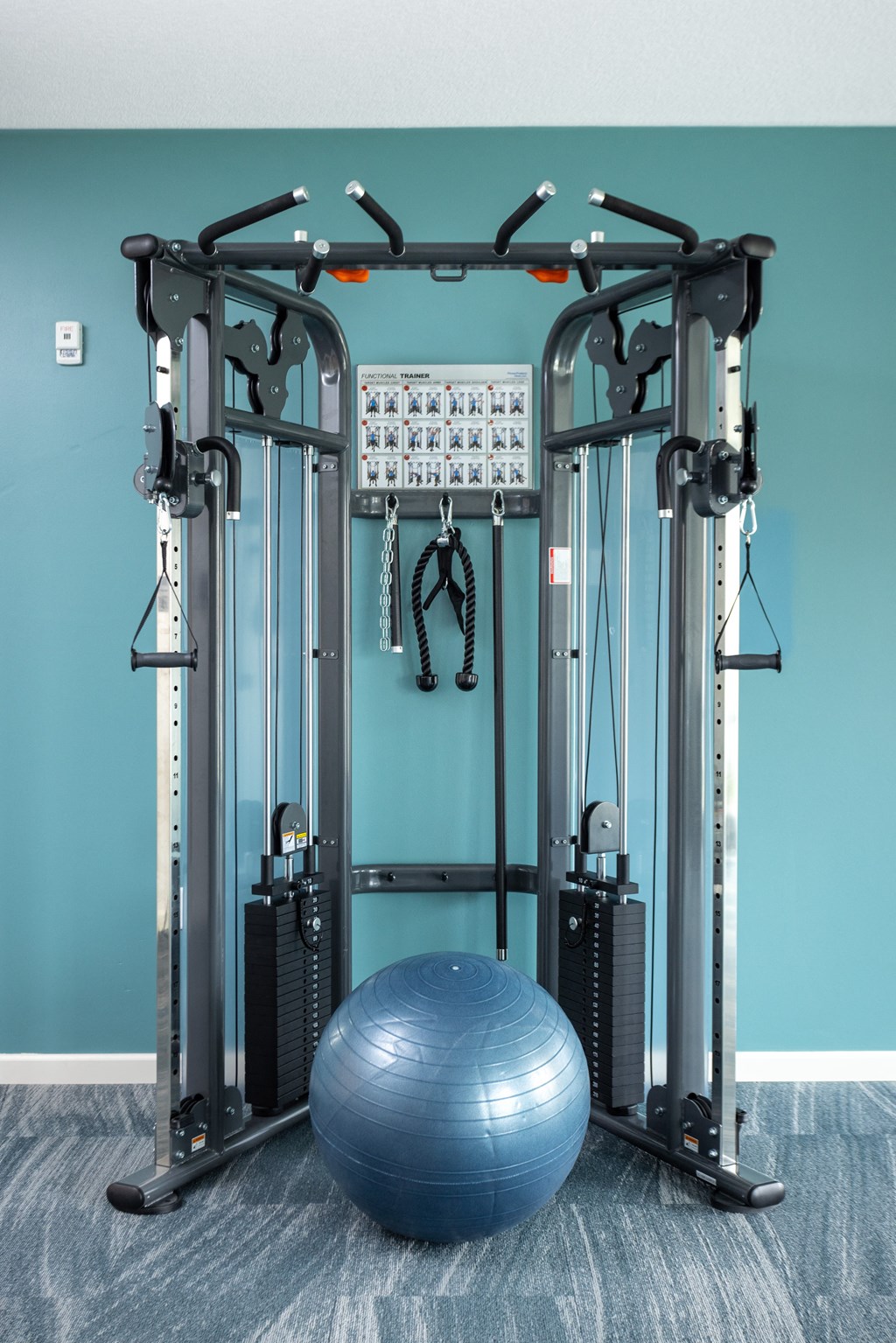 a gym ball and equipment in a room with a blue wall