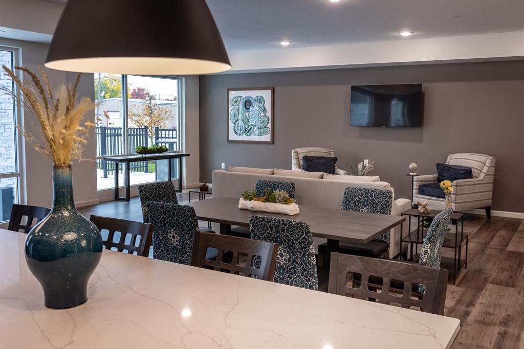 a living room with a table and chairs and a tv
