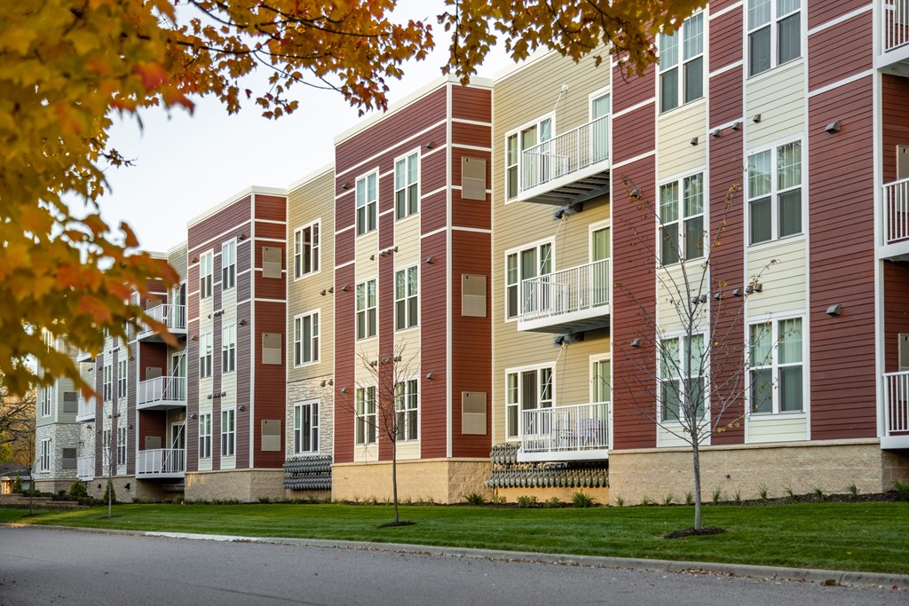 a row of apartment buildings on the side of a street
