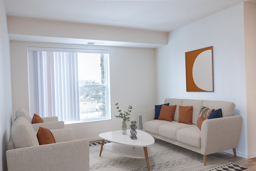 a living room with a couch and a table and a window