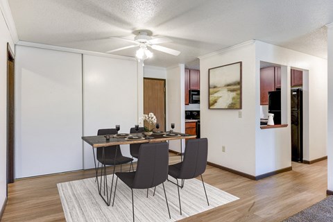 a dining room with a table and chairs and a ceiling fan